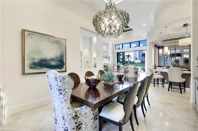a dining room with furniture a rug and a chandelier