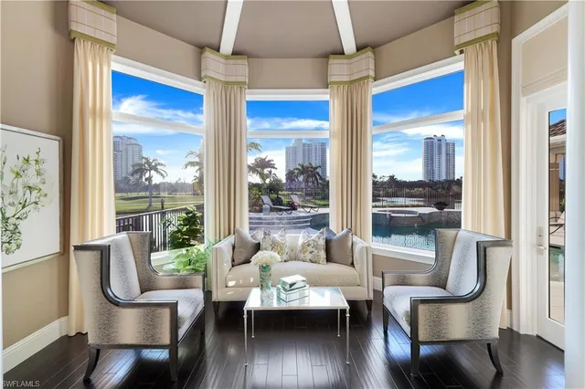 a living room with furniture and a floor to ceiling window