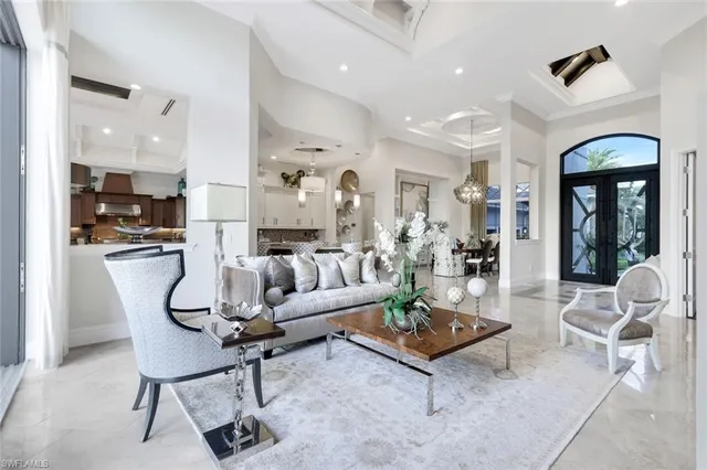 a living room with furniture kitchen view and a table