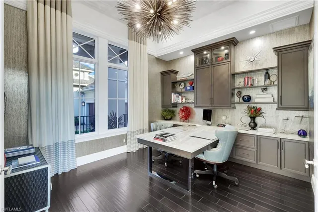 a spacious bedroom with a bed and a chandelier