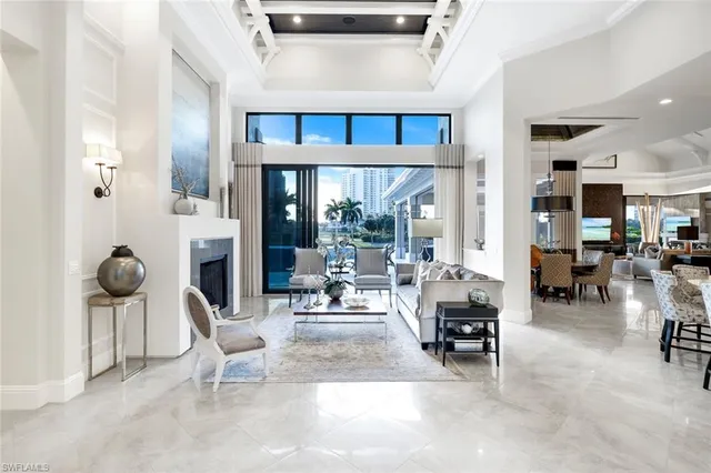 a living room with furniture and kitchen view