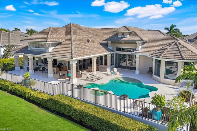 a view of a swimming pool with outdoor seating