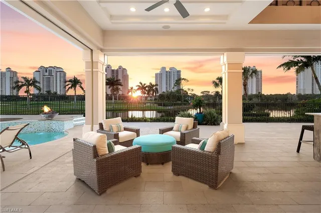 a front view of a house with a garden and lake view