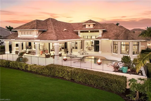 an aerial view of a house with garden space and ocean view