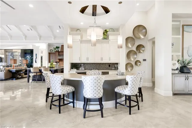a view of a dining room with furniture and chandelier