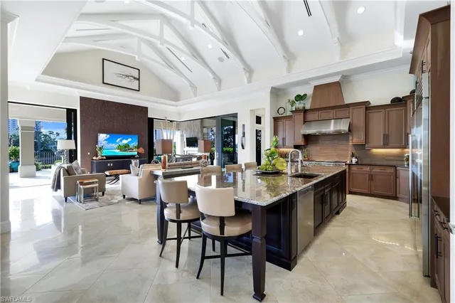 a large kitchen with a table and chairs