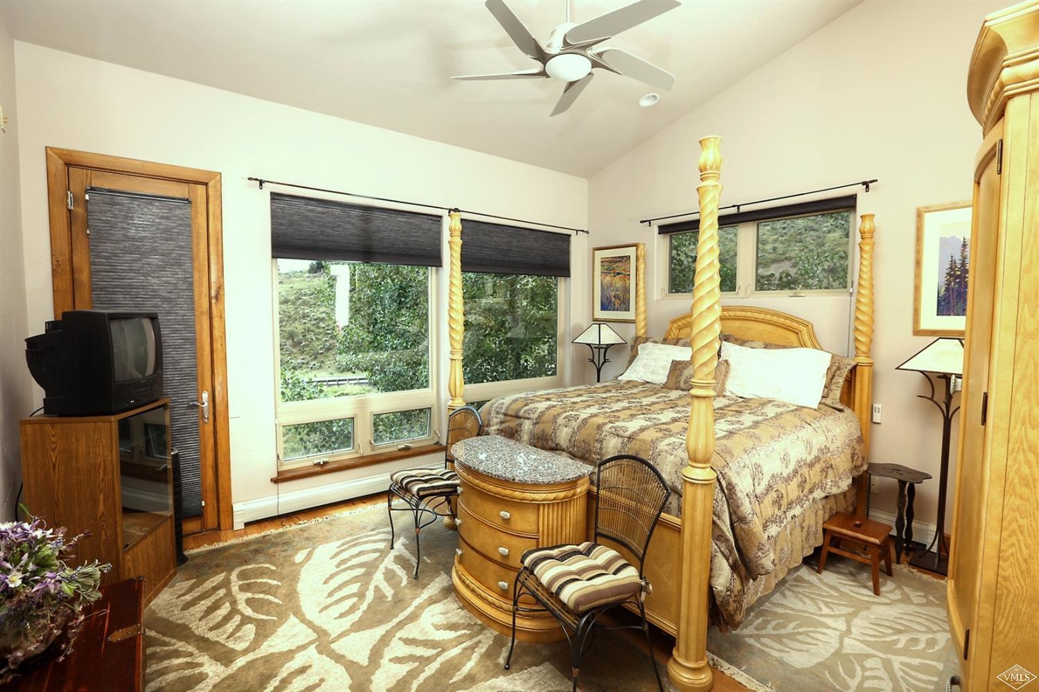 5015 Wildridge Road East, Unit A Avon, CO 81620 - Photo 12 of 22 a bedroom with a bed and large window
