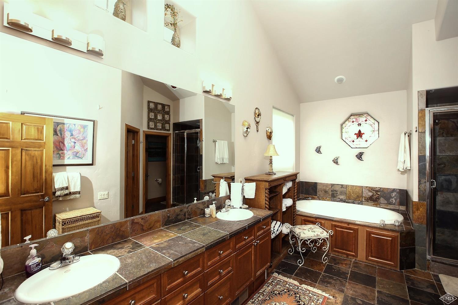 5015 Wildridge Road East, Unit A Avon, CO 81620 - Photo 13 of 22 a bathroom with a granite countertop sink and a mirror