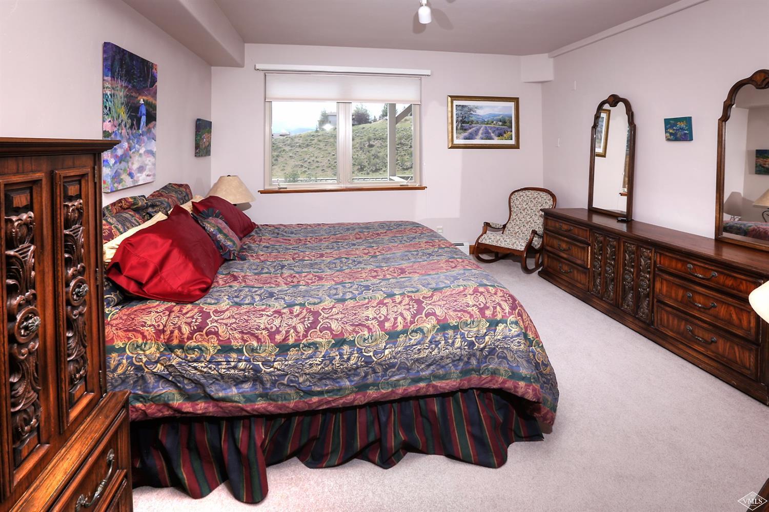 5015 Wildridge Road East, Unit A Avon, CO 81620 - Photo 14 of 22 a bedroom with bed and wooden floor