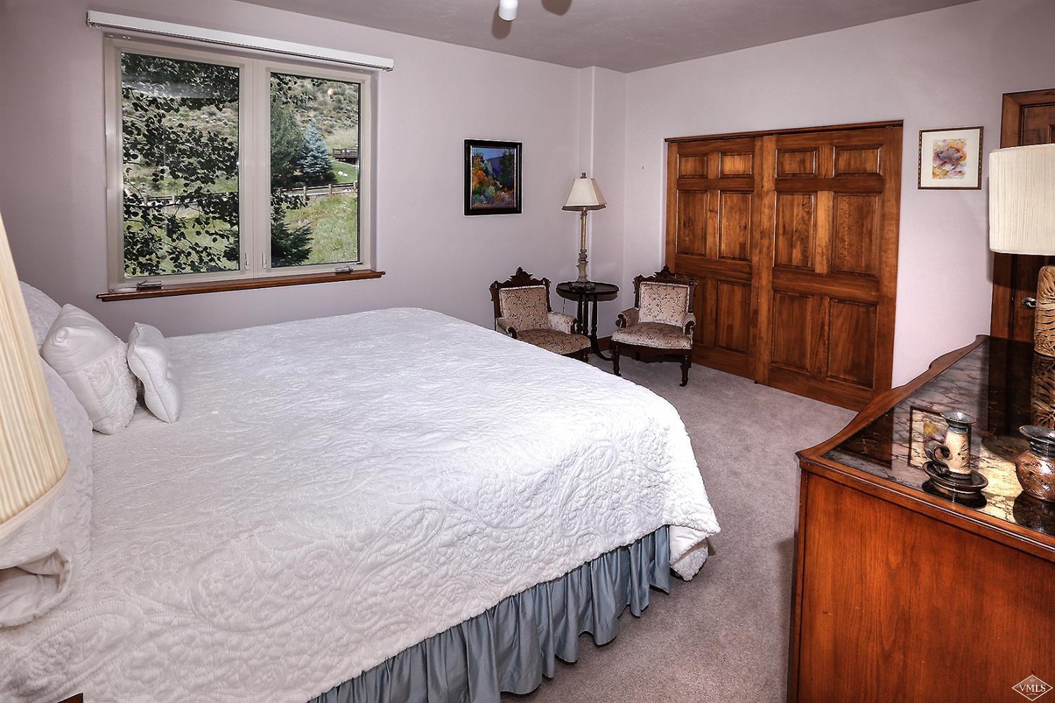 5015 Wildridge Road East, Unit A Avon, CO 81620 - Photo 16 of 22 a bedroom with a bed and a window