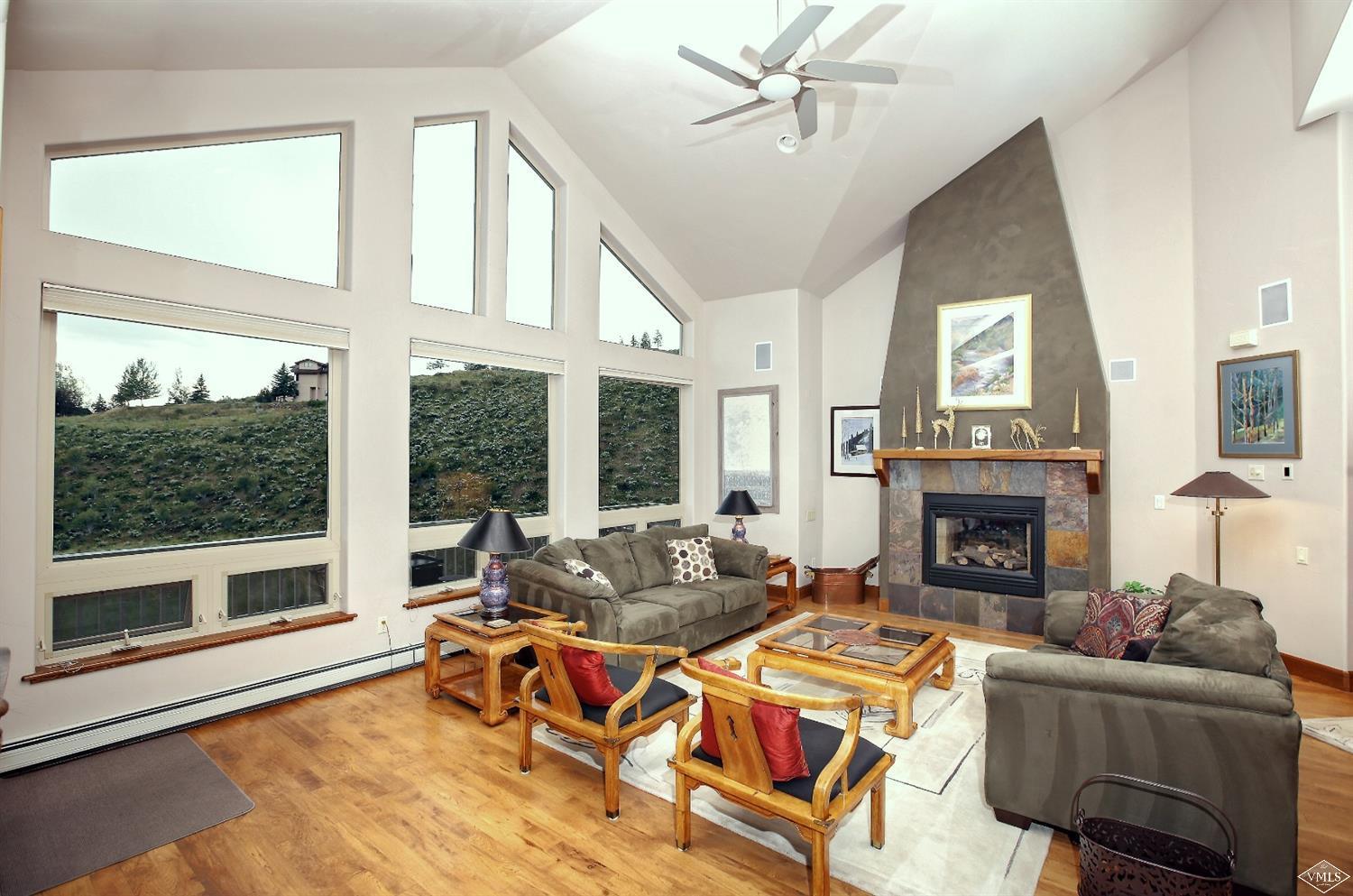 5015 Wildridge Road East, Unit A Avon, CO 81620 - Photo 4 of 22 a living room with furniture a large window and a fireplace