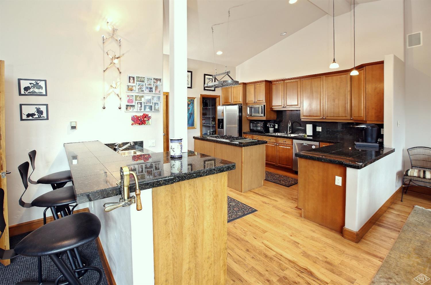 5015 Wildridge Road East, Unit A Avon, CO 81620 - Photo 7 of 22 a kitchen with granite countertop a sink stove and cabinets