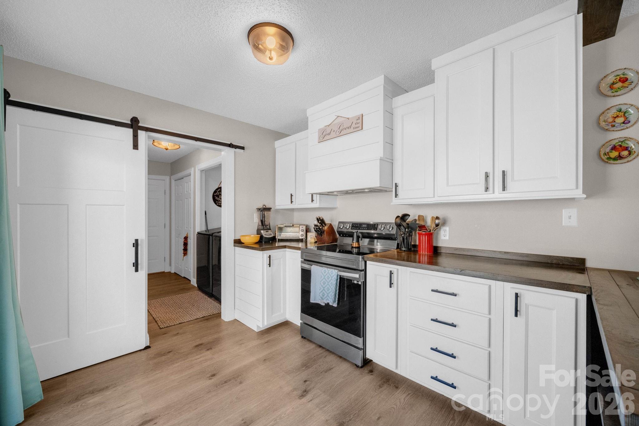 2581 Double Island Road Green Mountain, NC 28740 - Photo 12 of 48 a kitchen with white cabinets and white appliances