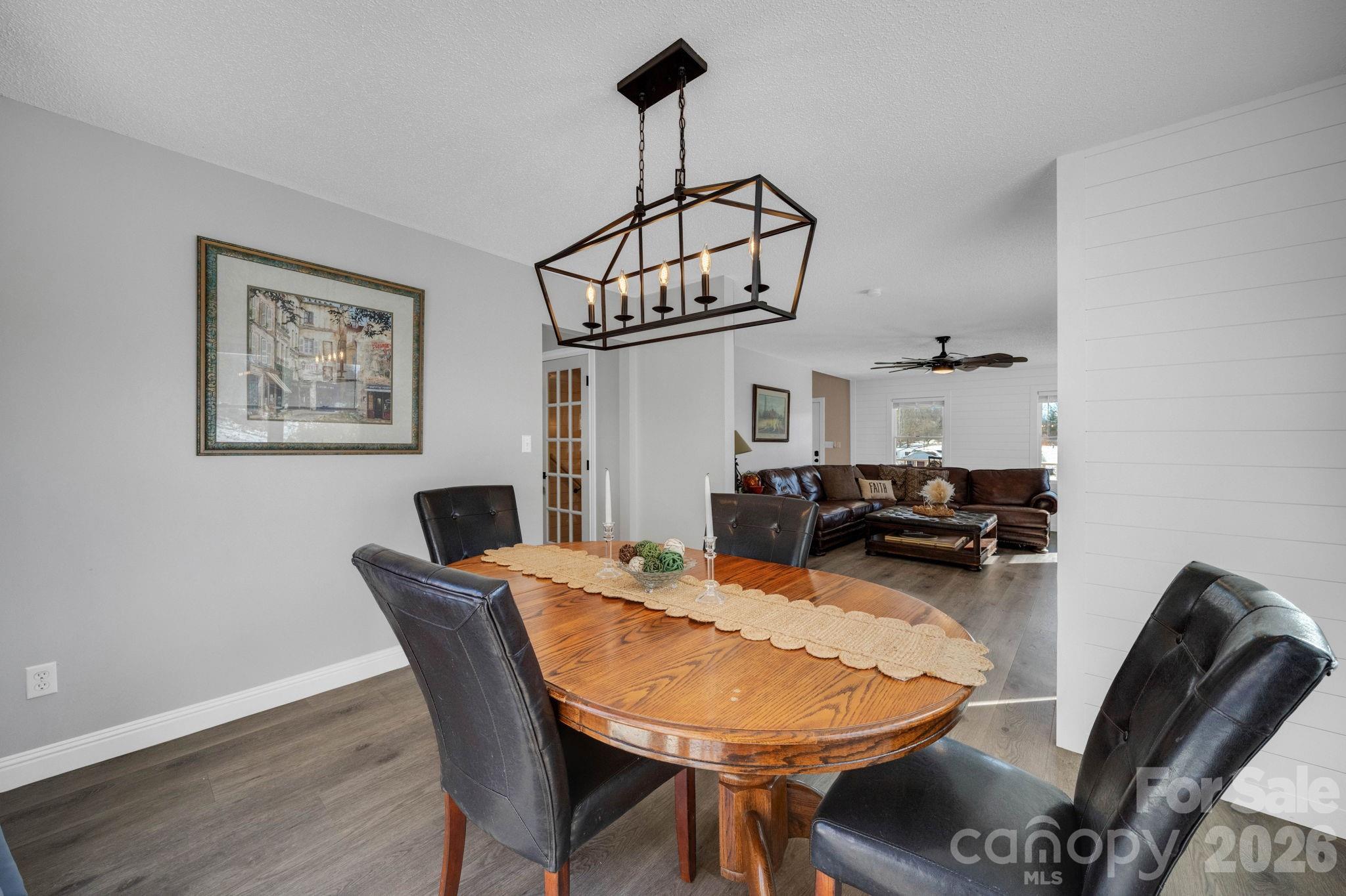 2581 Double Island Road Green Mountain, NC 28740 - Photo 13 of 48 a view of a dining room with furniture wooden floor and chandelier