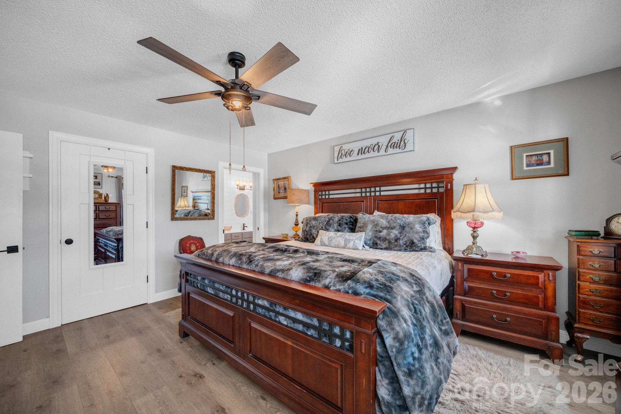 2581 Double Island Road Green Mountain, NC 28740 - Photo 16 of 48 a bed room with a bed and a chandelier