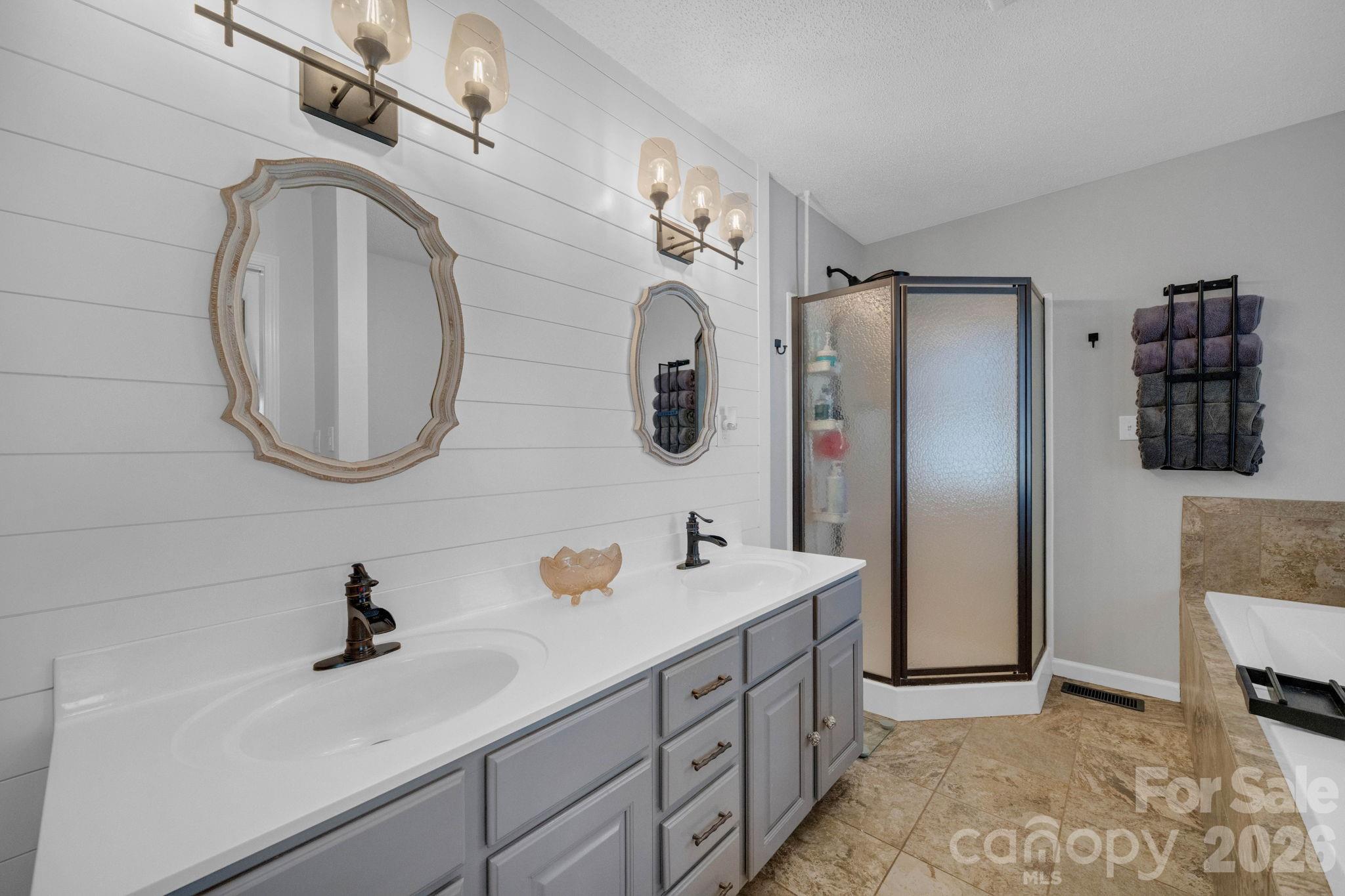 2581 Double Island Road Green Mountain, NC 28740 - Photo 19 of 48 a bathroom with a sink double vanity and a mirror