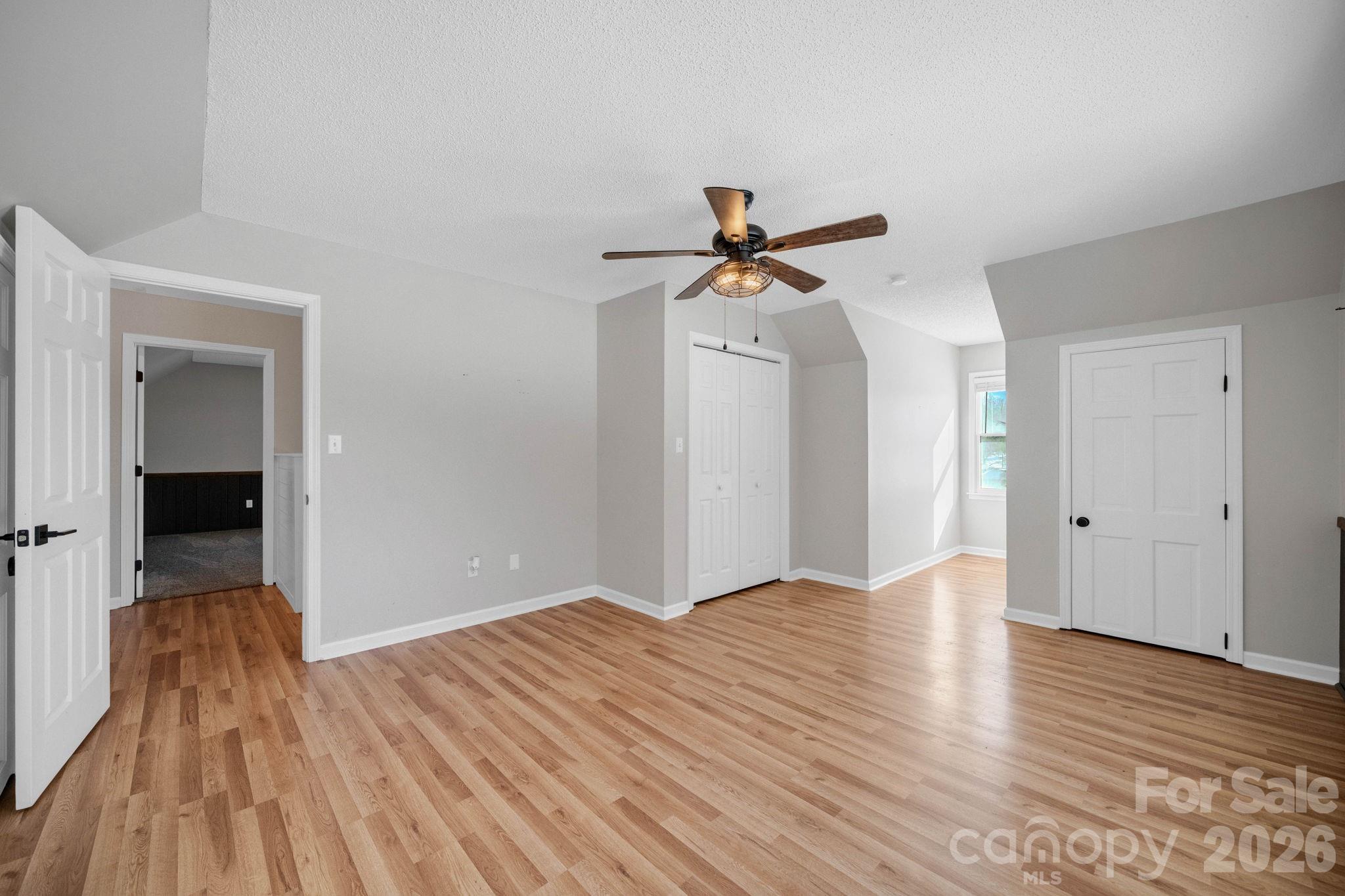2581 Double Island Road Green Mountain, NC 28740 - Photo 23 of 48 a view of a room with wooden floor and a ceiling fan