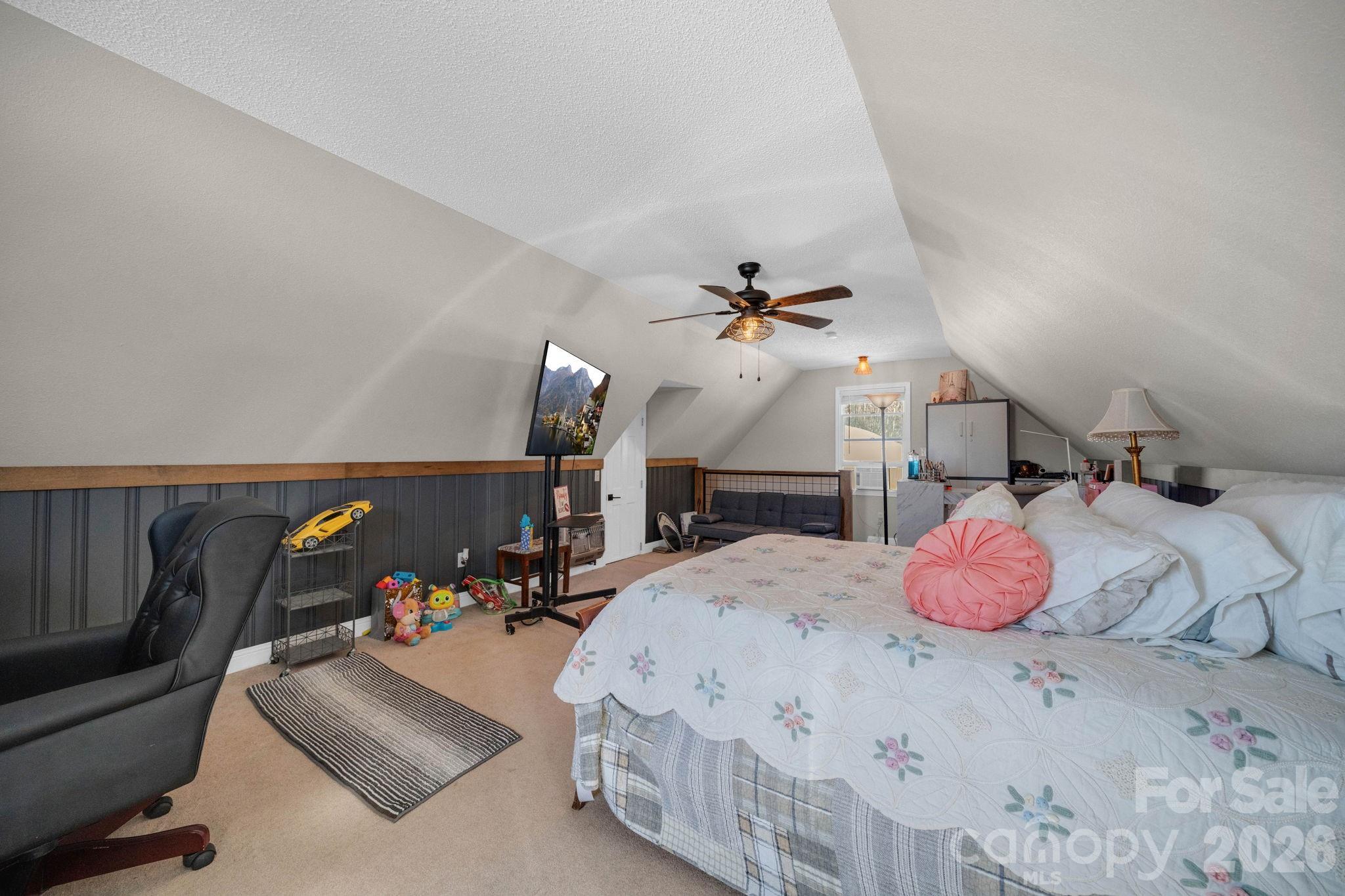 2581 Double Island Road Green Mountain, NC 28740 - Photo 28 of 48 a bedroom with a bed and potted plant