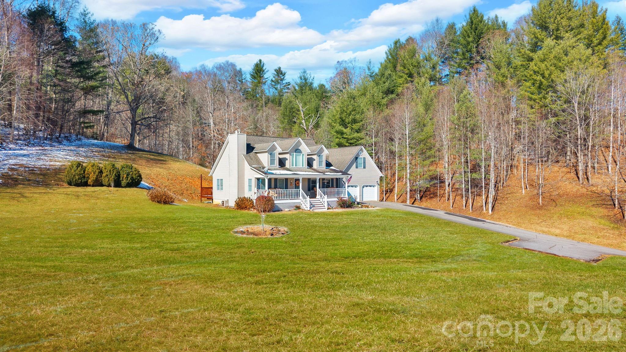 2581 Double Island Road Green Mountain, NC 28740 - Photo 3 of 48 a backyard of a house with table and chairs