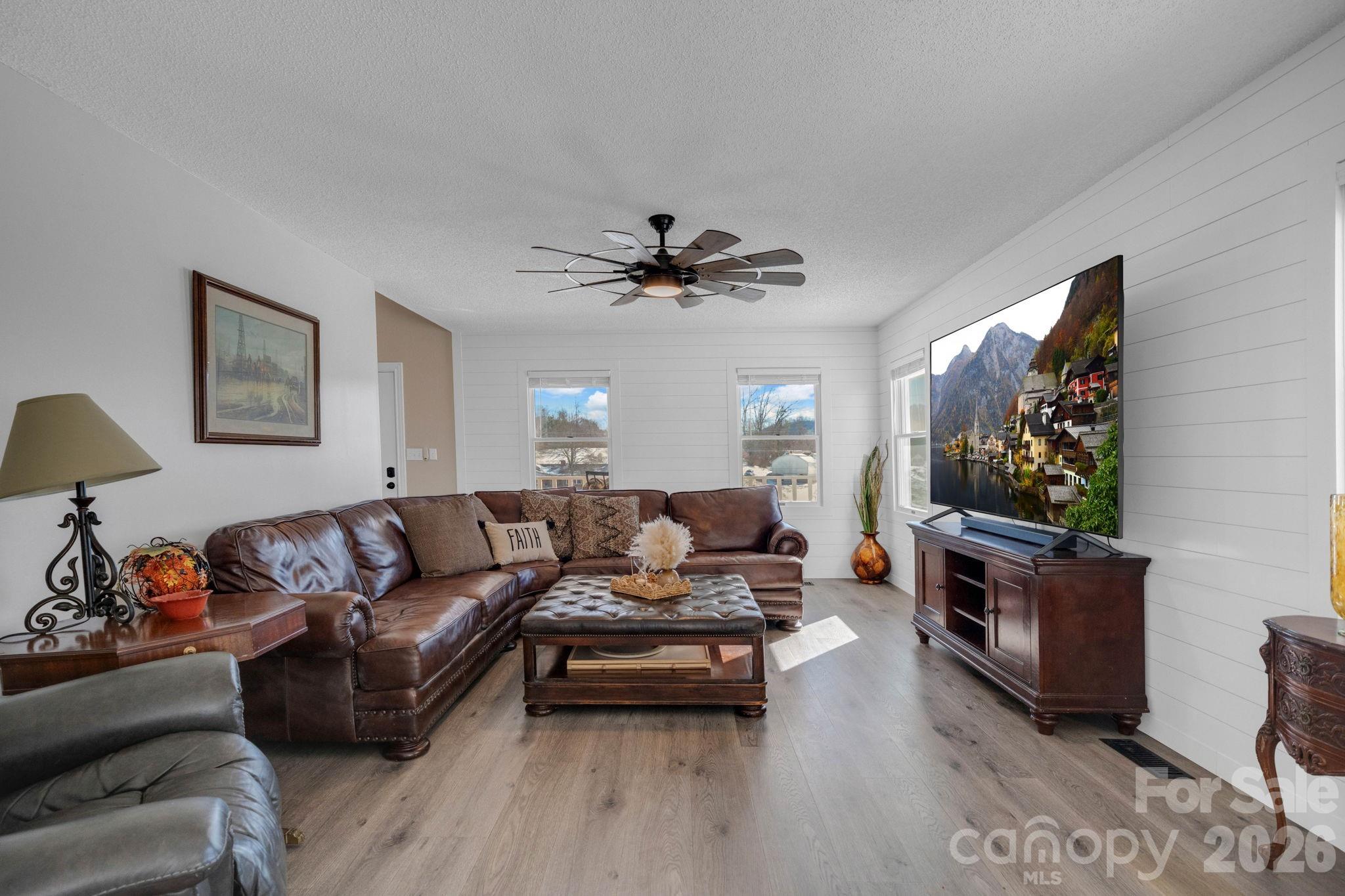 2581 Double Island Road Green Mountain, NC 28740 - Photo 7 of 48 a living room with furniture a flat screen tv and a fireplace
