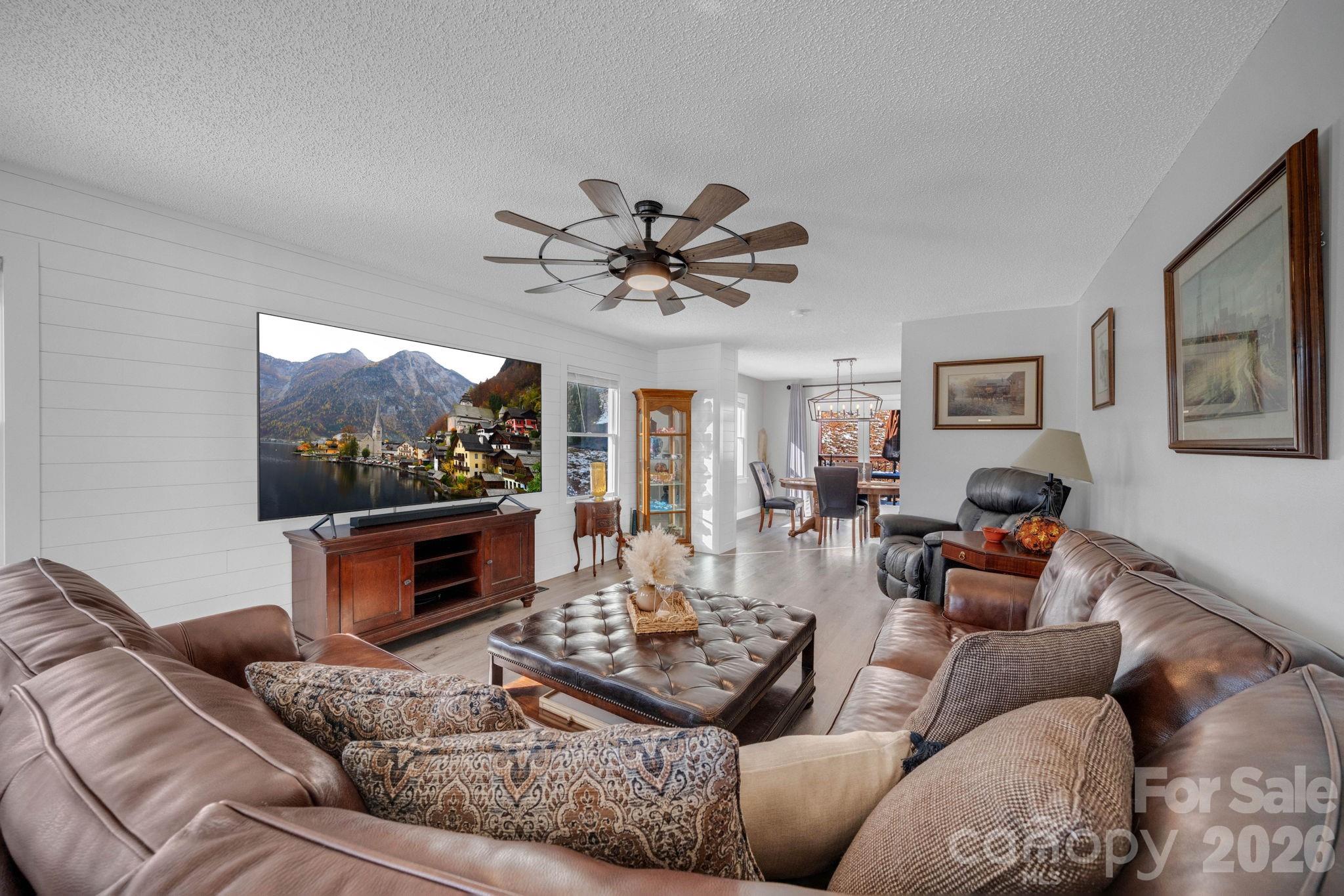2581 Double Island Road Green Mountain, NC 28740 - Photo 9 of 48 a living room with furniture a flat screen tv and a fireplace