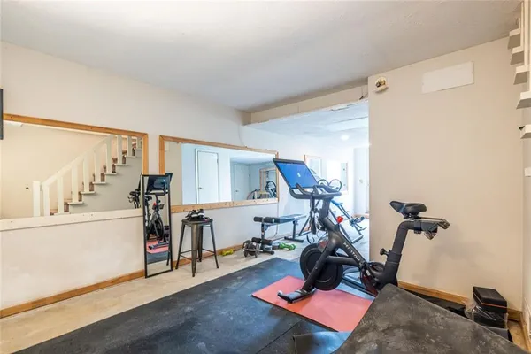 a room with furniture and gym equipment