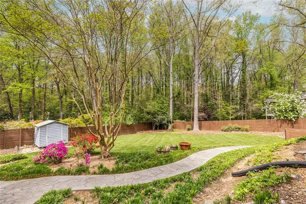 a view of a garden with flowers and trees