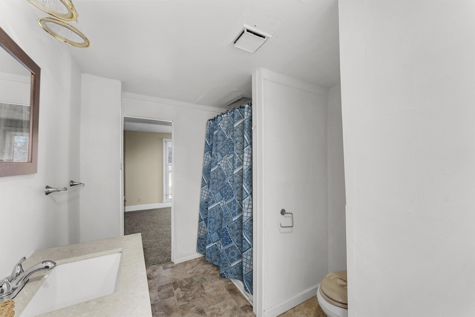 2202 Pershing Boulevard Clinton, IA 52732 - Photo 18 of 32 a bathroom with a shower a toilet and a sink