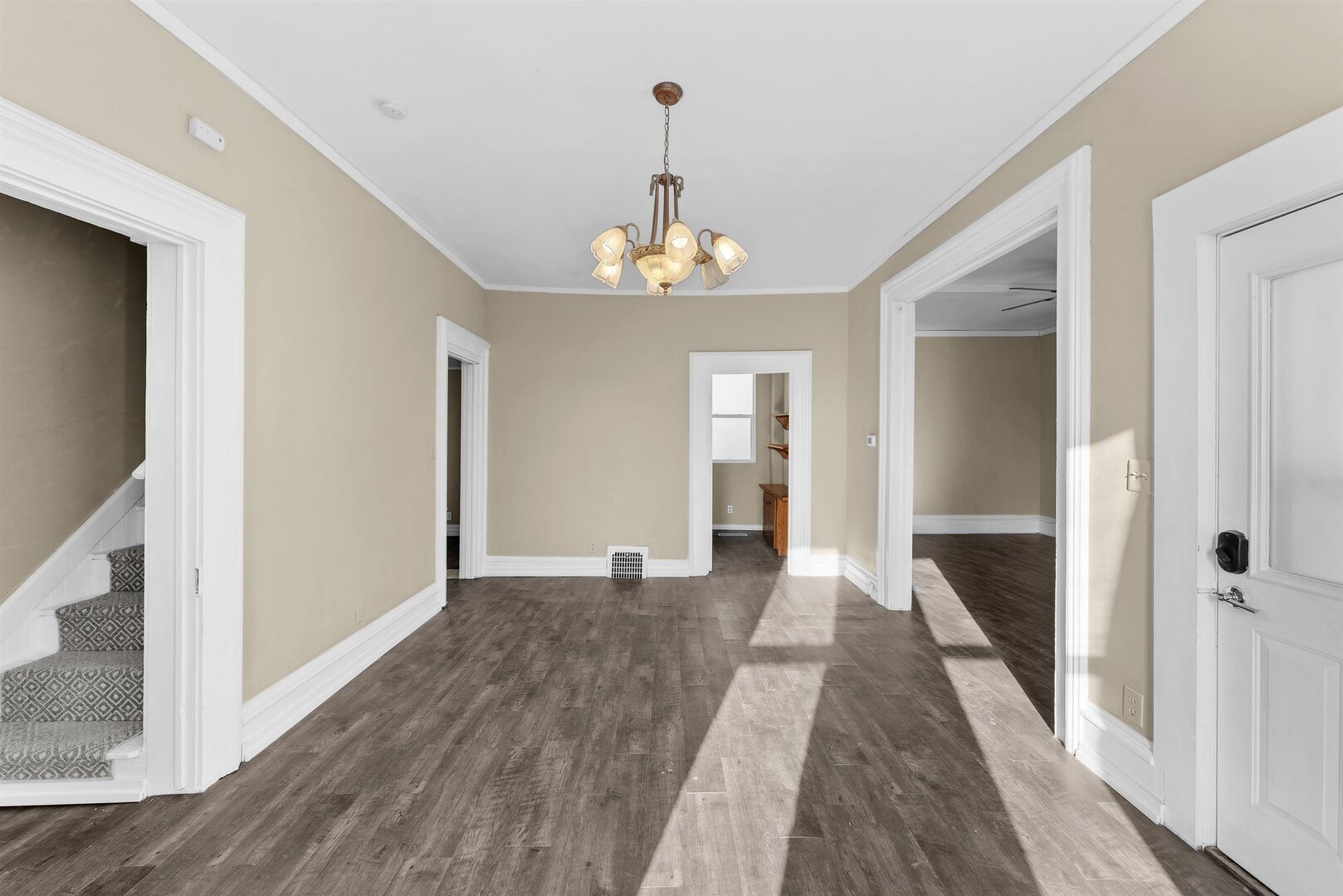 2202 Pershing Boulevard Clinton, IA 52732 - Photo 2 of 32 a view of a hallway with wooden floor and staircase
