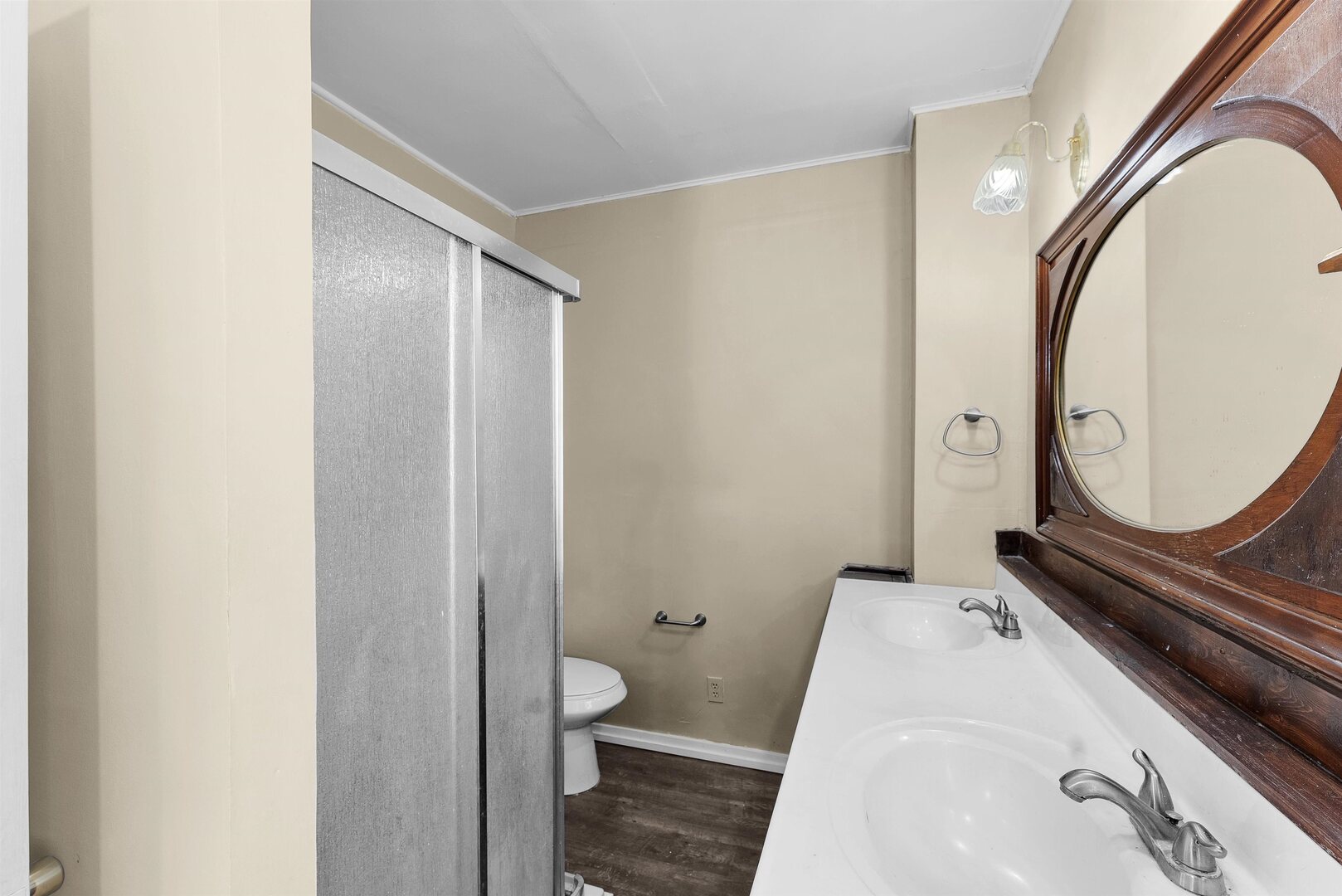 2202 Pershing Boulevard Clinton, IA 52732 - Photo 6 of 32 a bathroom with a toilet a sink and a mirror