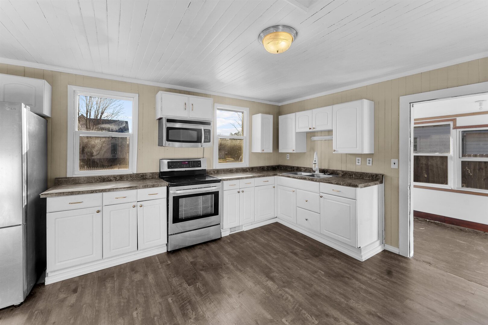 2202 Pershing Boulevard Clinton, IA 52732 - Photo 9 of 32 a kitchen with granite countertop white cabinets and stainless steel appliances