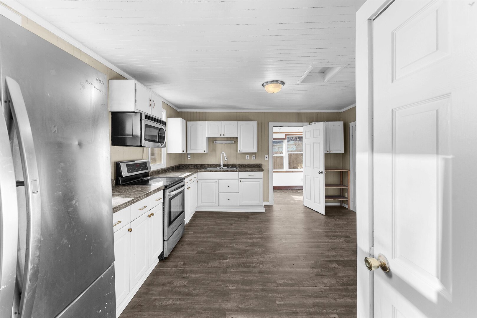 2202 Pershing Boulevard Clinton, IA 52732 - Photo 10 of 32 a large kitchen with cabinets and stainless steel appliances