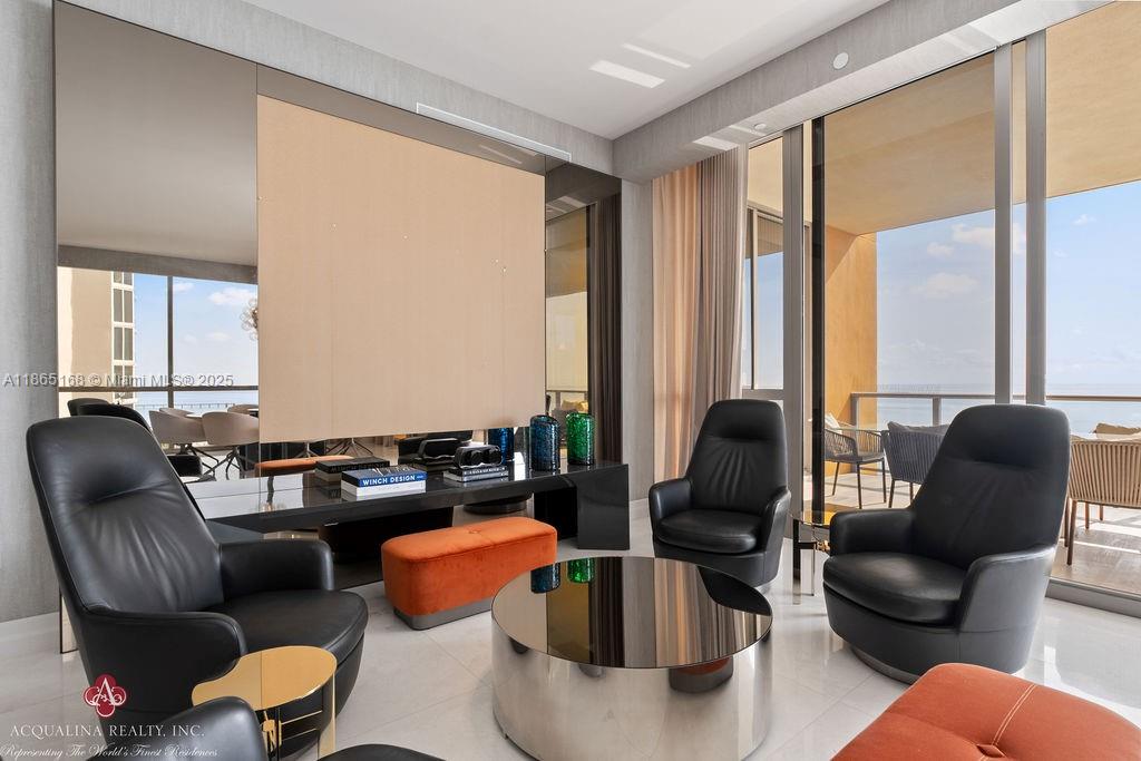 17749 Collins Avenue, Unit 902 Sunny Isles Beach, FL 33160 - Photo 13 of 82 a living room with furniture and floor to ceiling windows