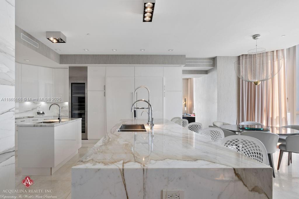 17749 Collins Avenue, Unit 902 Sunny Isles Beach, FL 33160 - Photo 28 of 82 a kitchen with stainless steel appliances kitchen island granite countertop a sink and cabinets