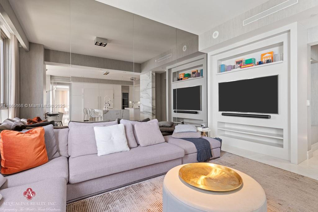 17749 Collins Avenue, Unit 902 Sunny Isles Beach, FL 33160 - Photo 35 of 82 a living room with furniture and a flat screen tv
