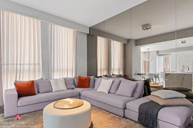 a bedroom with two beds and a large window