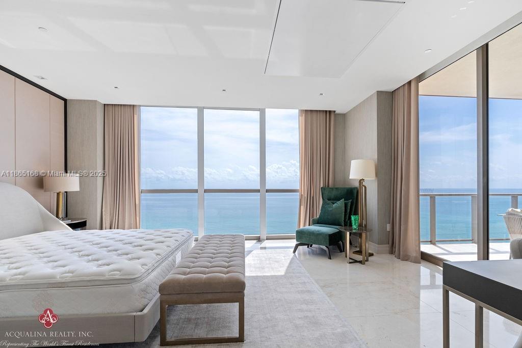 17749 Collins Avenue, Unit 902 Sunny Isles Beach, FL 33160 - Photo 39 of 82 a bedroom with a bed and large windows
