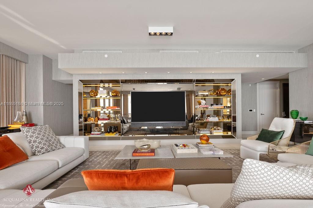 17749 Collins Avenue, Unit 902 Sunny Isles Beach, FL 33160 - Photo 4 of 82 a living room with furniture and a flat screen tv