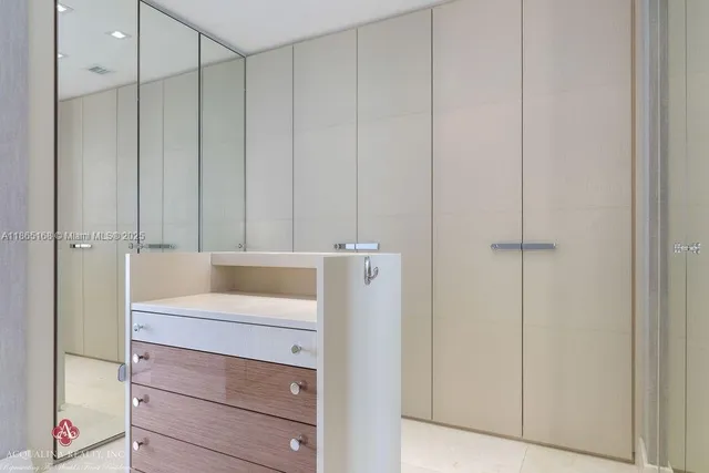 a view of a bedroom with furniture and large windows