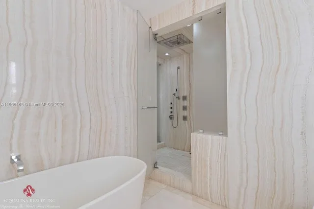 a spacious bedroom with a bed and a flat screen tv