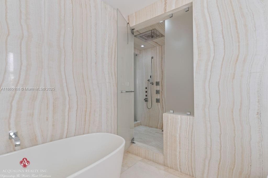 17749 Collins Avenue, Unit 902 Sunny Isles Beach, FL 33160 - Photo 46 of 82 a bathroom with a bathtub and shower
