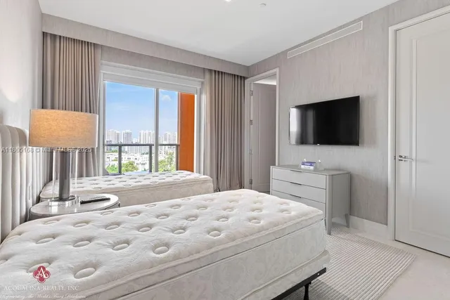 a bedroom with a bed and large window