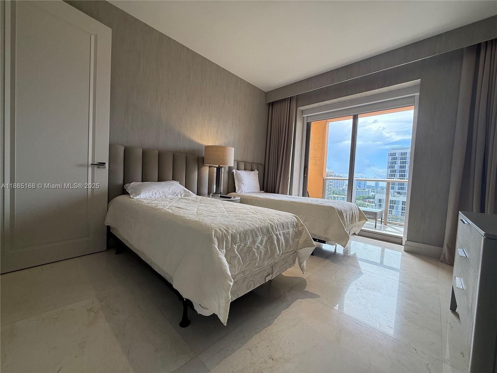 17749 Collins Avenue, Unit 902 Sunny Isles Beach, FL 33160 - Photo 51 of 82 a bedroom with a bed and large window