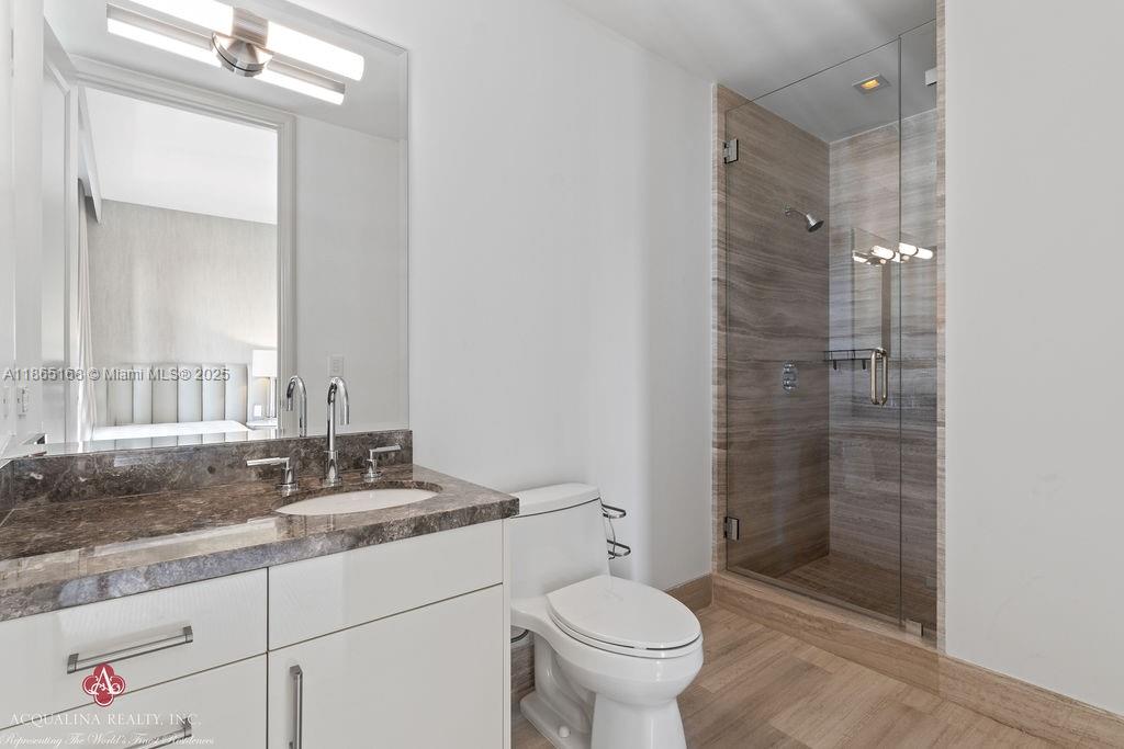 17749 Collins Avenue, Unit 902 Sunny Isles Beach, FL 33160 - Photo 52 of 82 a bathroom with a sink and a mirror