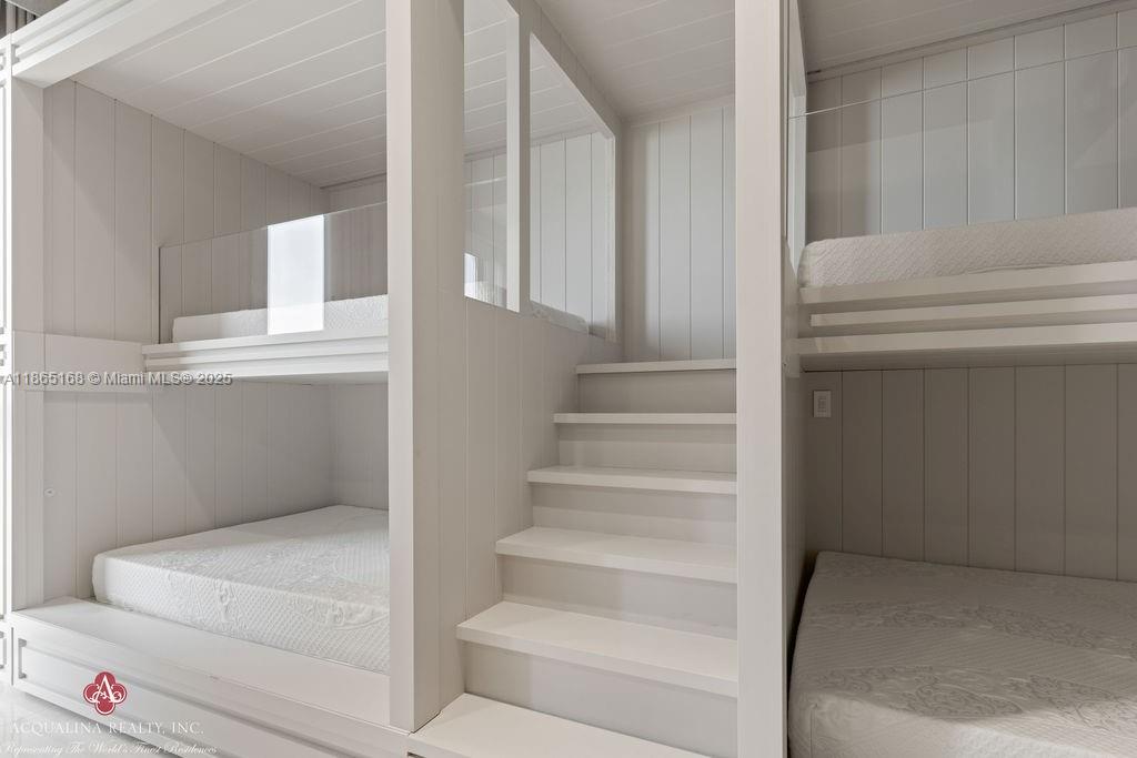 17749 Collins Avenue, Unit 902 Sunny Isles Beach, FL 33160 - Photo 58 of 82 a view of staircase with white walls and white door