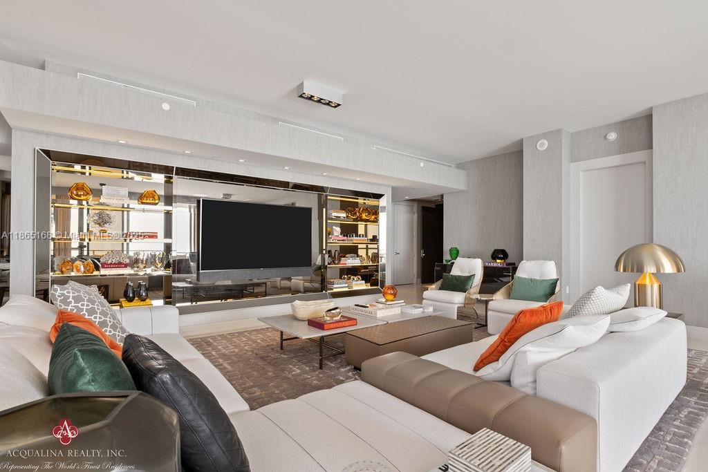 17749 Collins Avenue, Unit 902 Sunny Isles Beach, FL 33160 - Photo 6 of 82 a living room with furniture and a flat screen tv