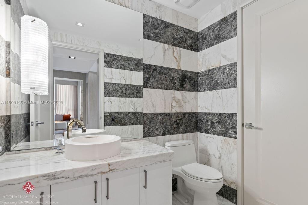 17749 Collins Avenue, Unit 902 Sunny Isles Beach, FL 33160 - Photo 64 of 82 a bathroom with a sink toilet and shower