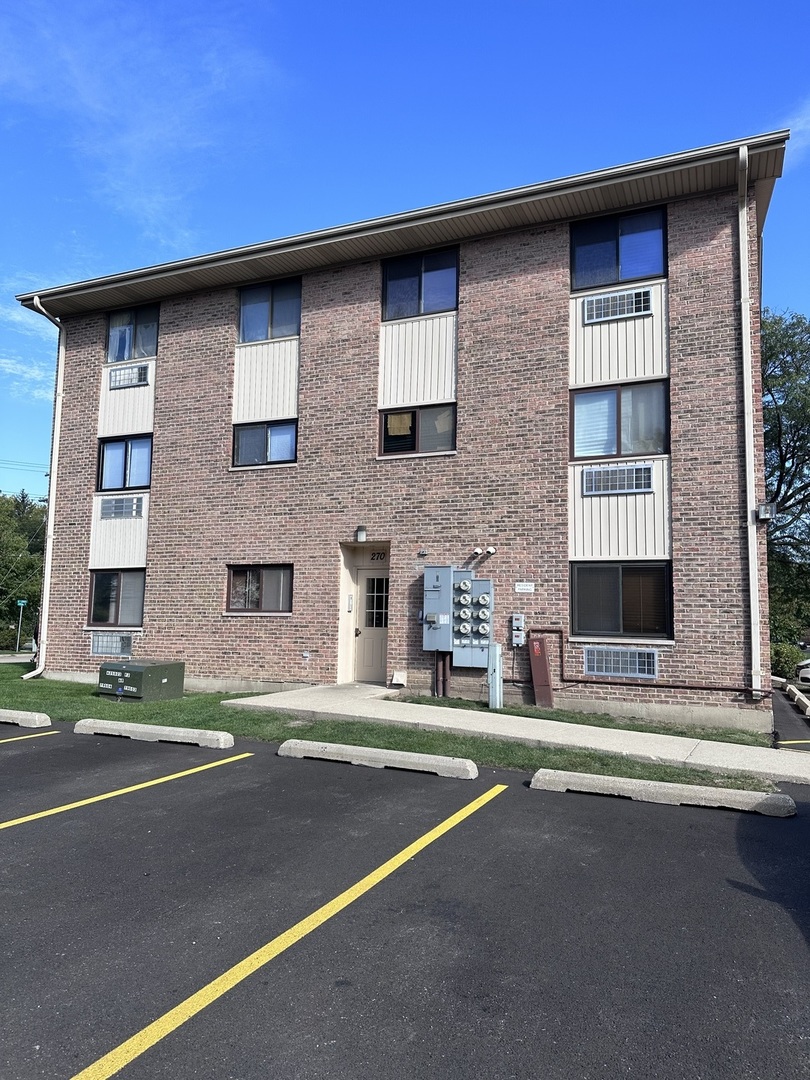 270 12th Street, Unit 2D Wheeling, IL 60090 - Photo 2 of 12 a front view of a building with a street