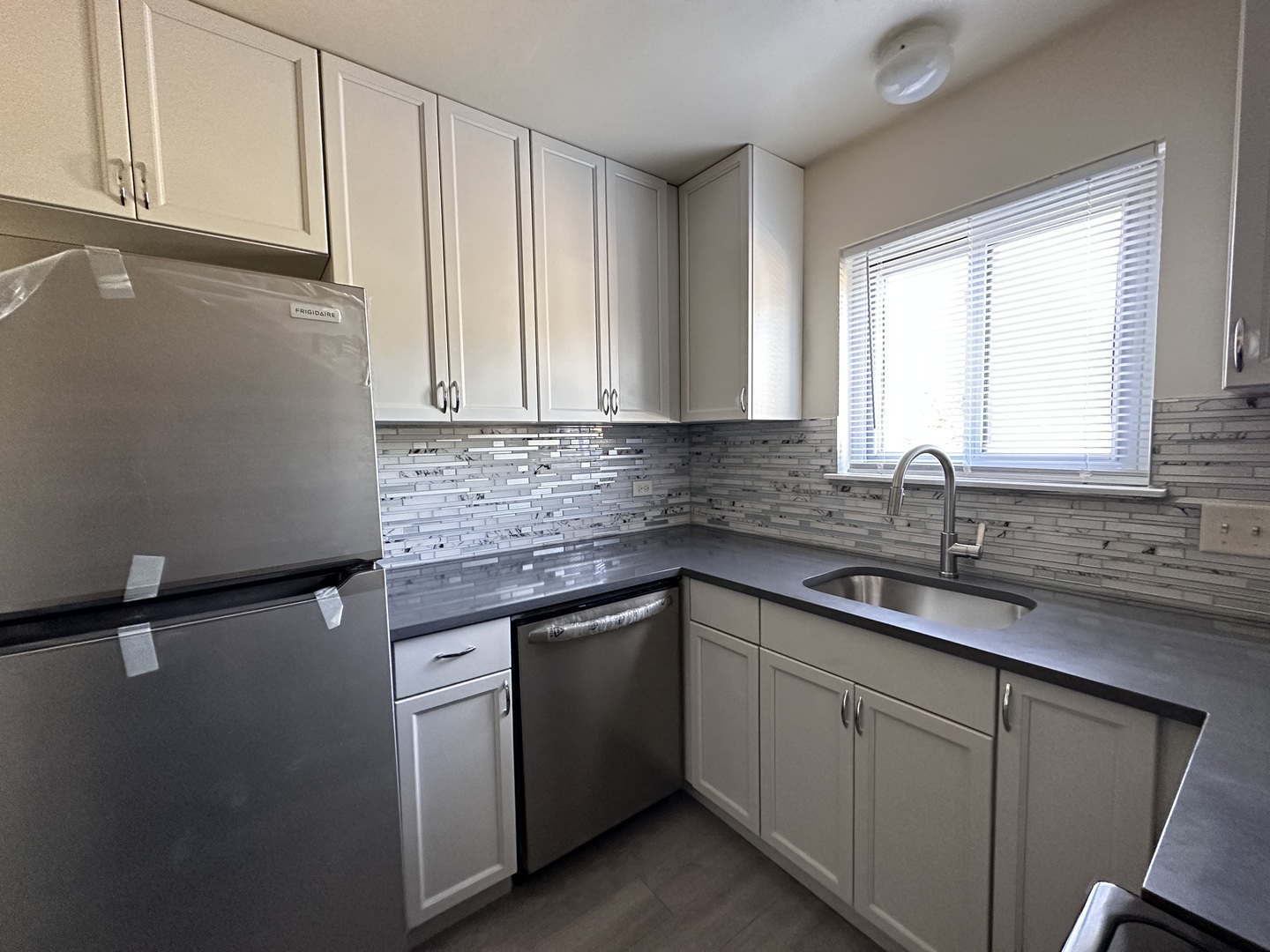 270 12th Street, Unit 2D Wheeling, IL 60090 - Photo 4 of 12 a kitchen with a sink cabinets and window