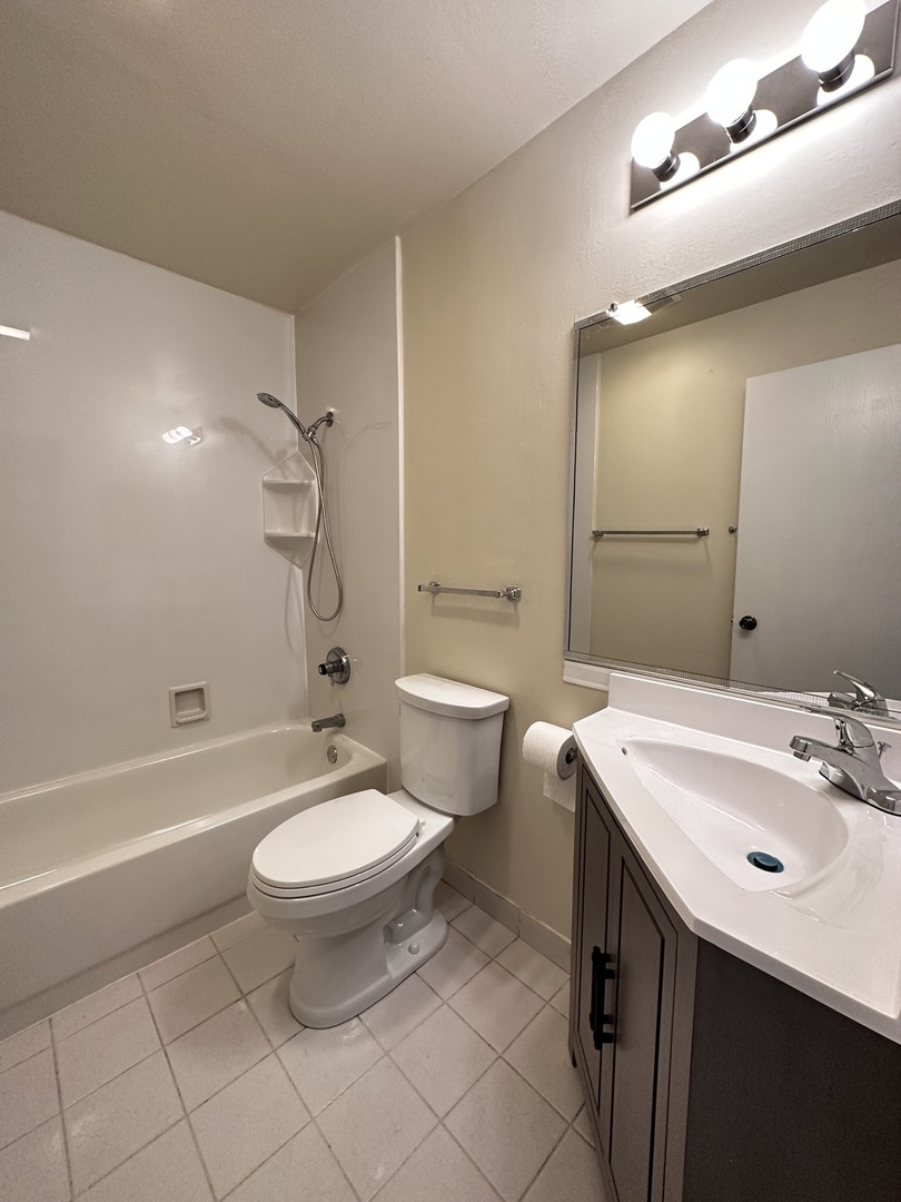 270 12th Street, Unit 2D Wheeling, IL 60090 - Photo 6 of 12 a bathroom with a sink toilet a mirror and bathtub